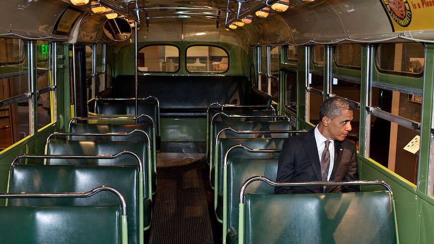 President Barack Obama sits in the Rosa Parks bus