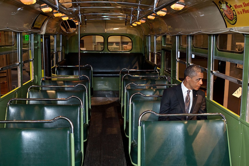 President Barack Obama sits in the Rosa Parks bus