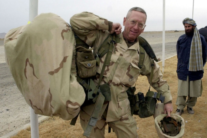 A younger James Mattis a large pack covered in camouflage print.