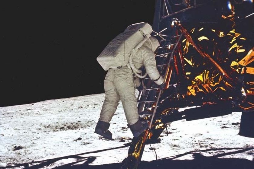 Buzz Aldrin takes his first step towards the surface of the Moon from Apollo 11's lunar module.