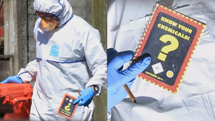 A forensic investigator wears a white disposable suit and carries a book called "know your chemicals"