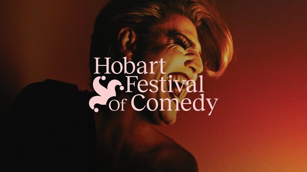 Reuben Kaye behind Hobart Festival of Comedy logo