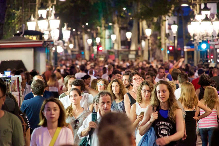 People walk along the Las ramblas pedestrian strip.