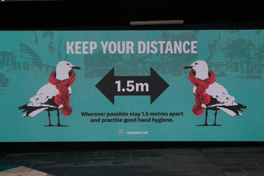 A sign showing two seagulls staying 1.5 metres apart, at Melbourne's Federation Square.