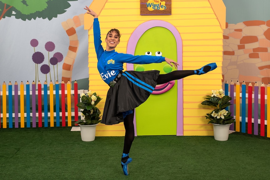 Evie Ferris dancing in a blue skivvy and ballet skirt.