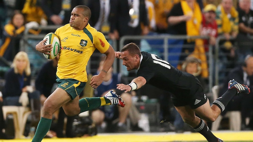 Australia's Will Genia evades the tackle of All Black Aaron Cruden to score a try in August 2013.