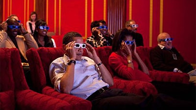 President Barack Obama and First Lady Michelle Obama wear 3-D glasses while watching the Super Bowl at a Super Bowl Party in ...