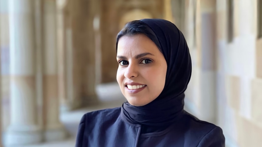Fatimah Almathami smiles at the camera wearing a headscarf.