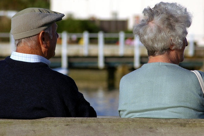 Two pensioners sit side by side on a park bench (File image: Julian May/photoxpress.com)