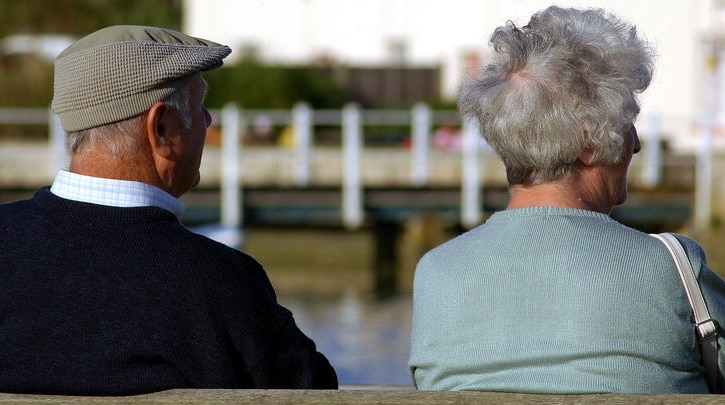 Senior citizens sit on a bench