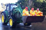Volunteers hitch a lift during flooding in Tinamba, Victoria.