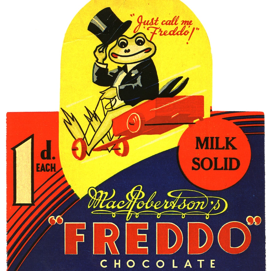 A colour line drawn chocolate wrapper featuring a cartoon frog in a top hat riding a billycart