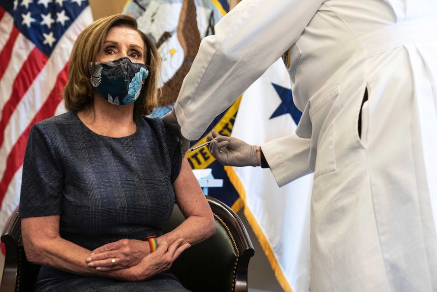 Speaker of the US House Nancy Pelosi receives a COVID-19 vaccine