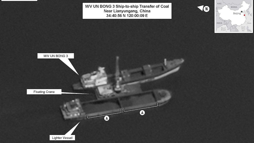 A black and white image shows a North Korean-flagged vessel conducting a ship-to-ship transfer.