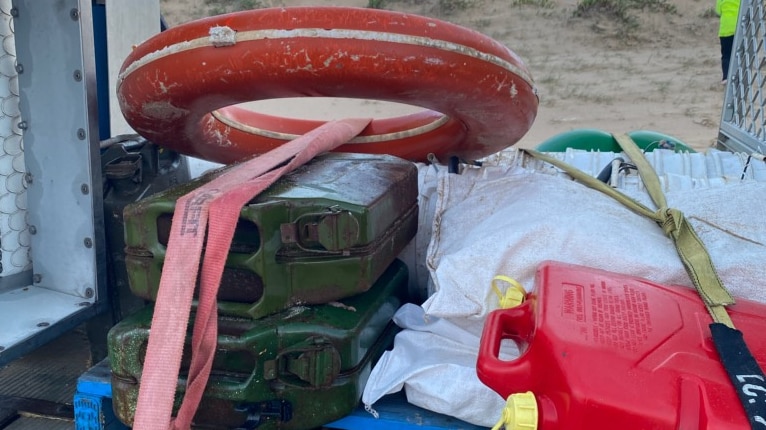 A life buoy, jerry cans and waterproof cases