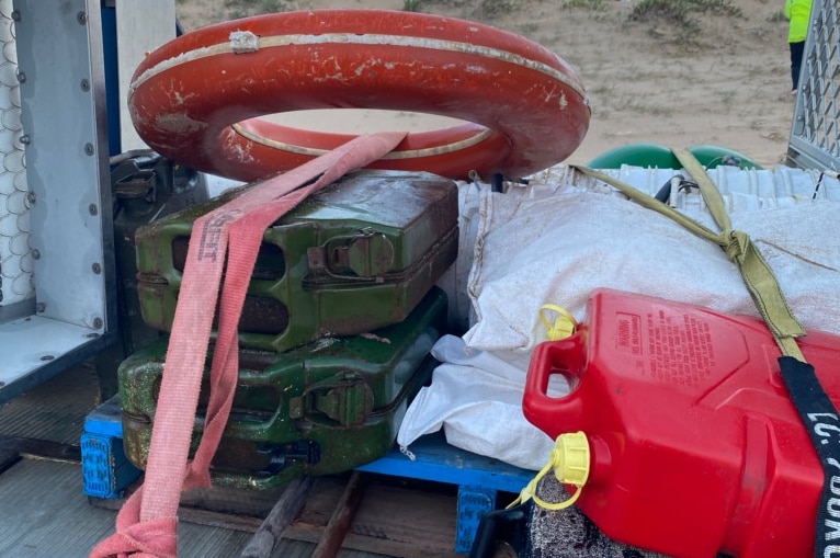 A life buoy, jerry cans and waterproof cases