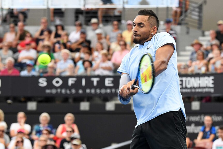 Australia's Nick Kyrgios plays a return to Alexandr Dolgopolov at the Brisbane International.