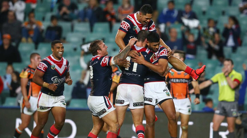 Man of the moment ... Sydney Roosters celebrate a Daniel Tupou try against the Tigers
