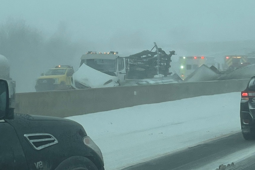 Numerous crashed cars on a road