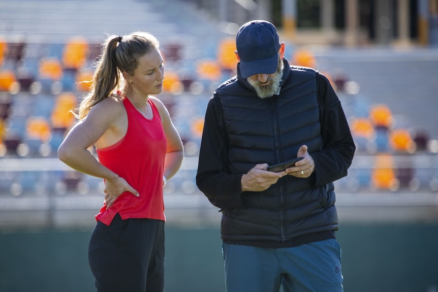 Riley Day listens to her coach Paul Pearce.