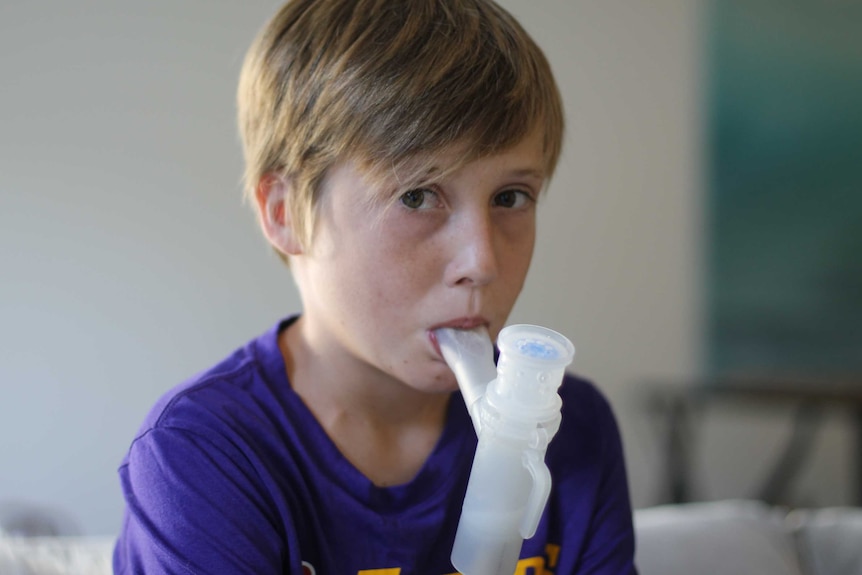 Kai Barton breathing into his nebulizer