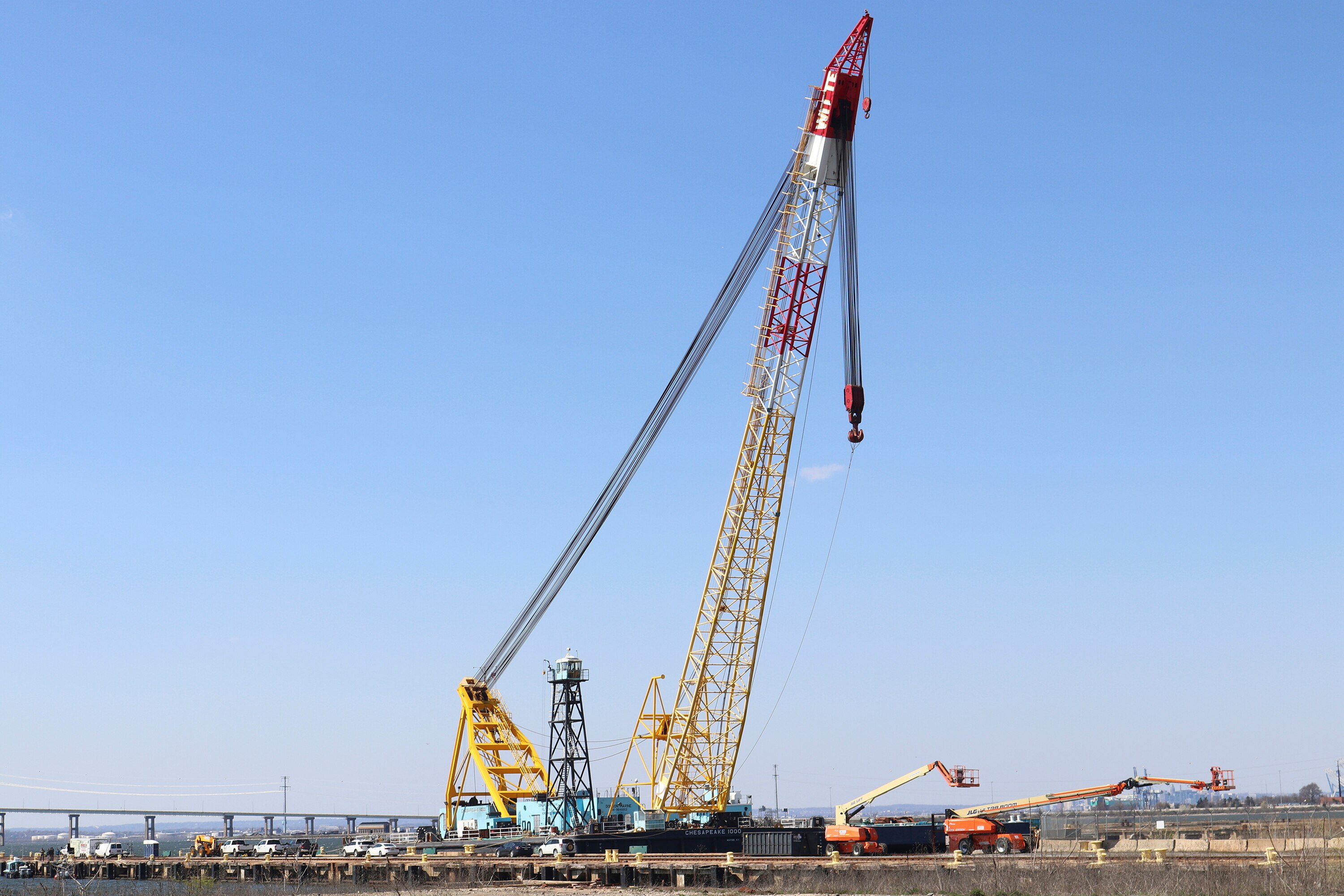 A large crane docked on land with a big blue sky above