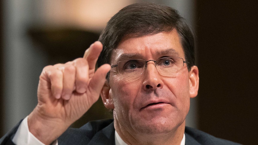 New US Secretary of Defence Mark Esper raises his hand, testifying before a Senate Armed Services Committee