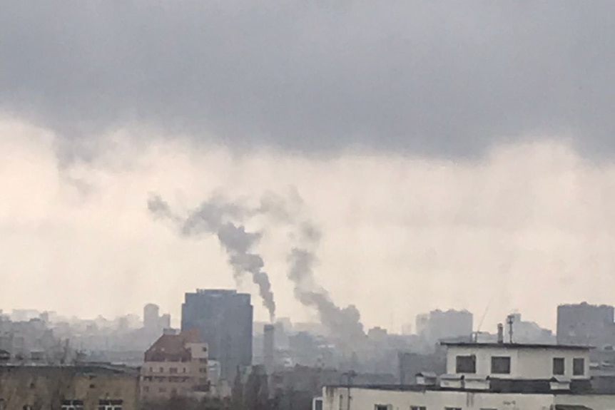 View of smoke rising over buildings. 