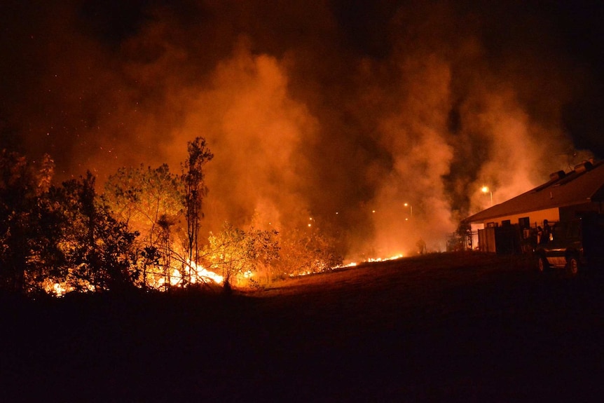 A grass fire moves close to a house in Johnston.