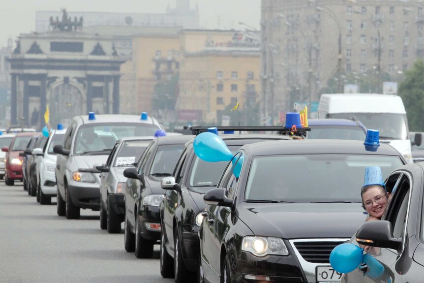 Cars have blue lights affixed to protest the use of lights by non emergency vehicles in moscow