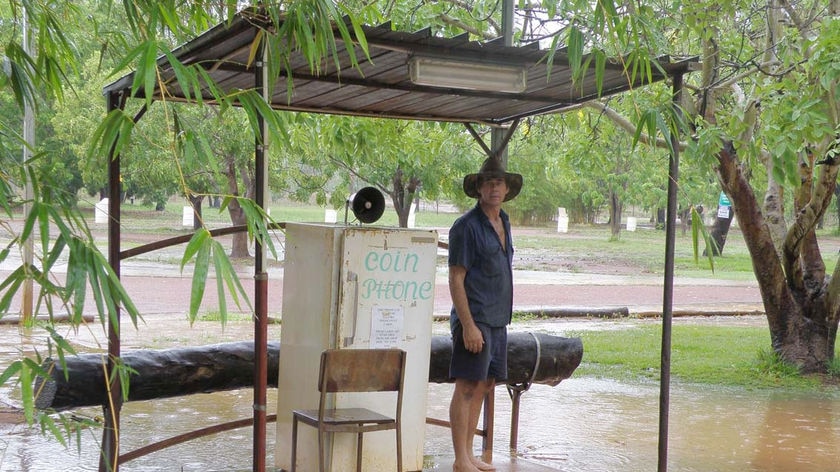 A farmer is surrounded by water on Drysdale Station which was hit with 40 millimetres of rain in 24 hours.