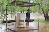 A farmer is surrounded by water on Drysdale Station which was hit with 40 millimetres of rain in 24 hours.