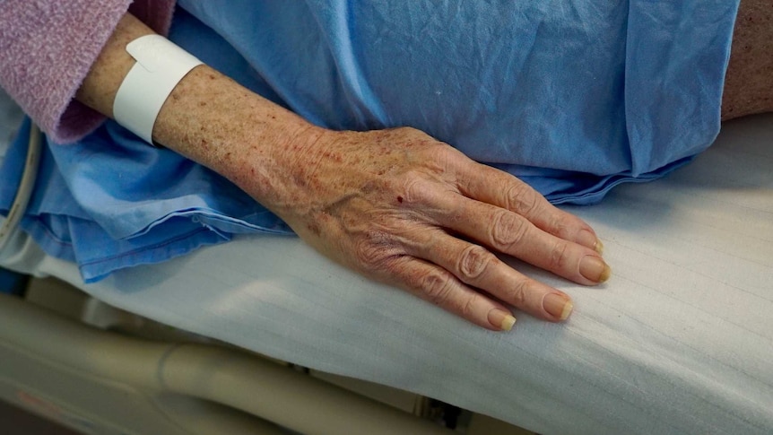 The hand of an elderly woman in hospital