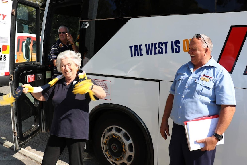 West Coast Eagles supporter Elina Bibiza and a bus driver boarding a bus to go the grand final in Melbourne.
