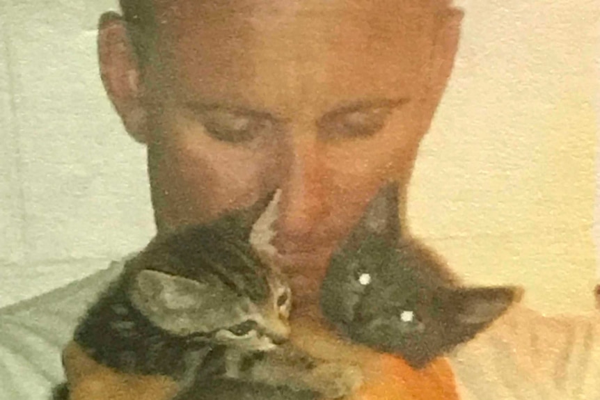 Scott Martin holding two kittens.