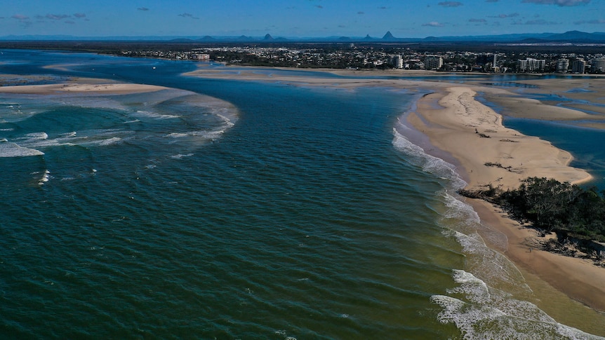 An aerial shot of a large body of water next to the shoreline