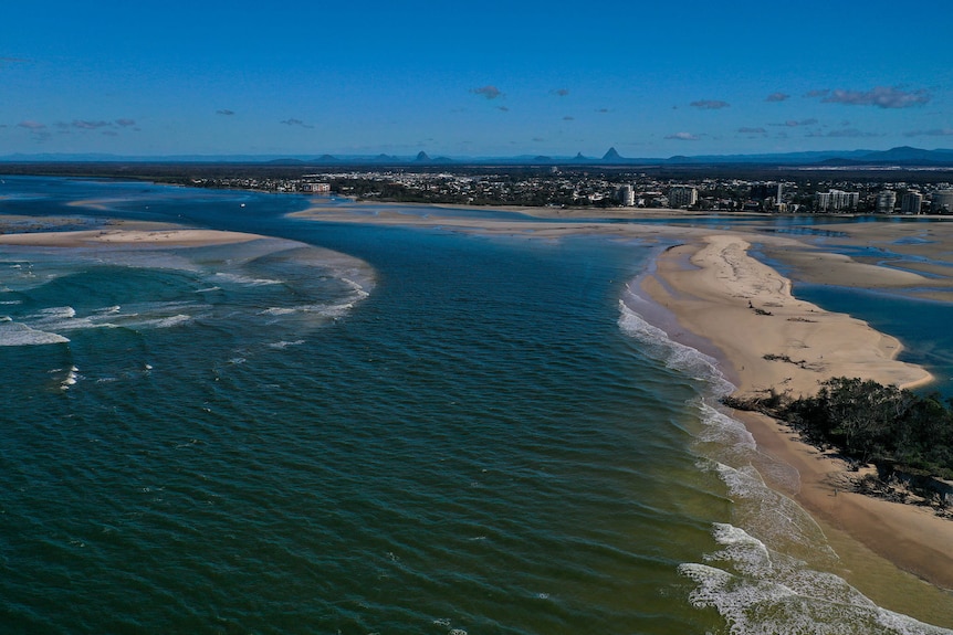 An aerial shot of a large body of water next to the shoreline