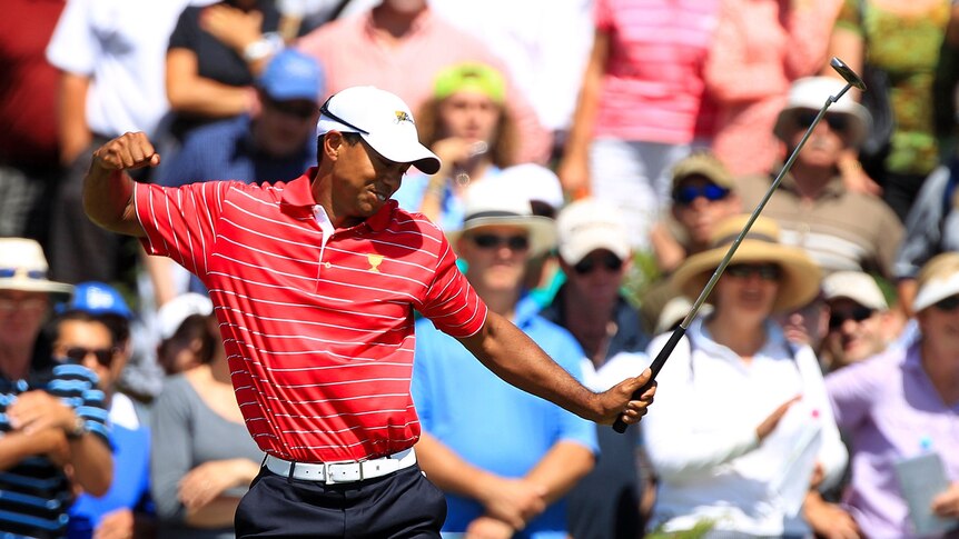 Tiger Woods punches the air after sinking a putt in Presidents Cup