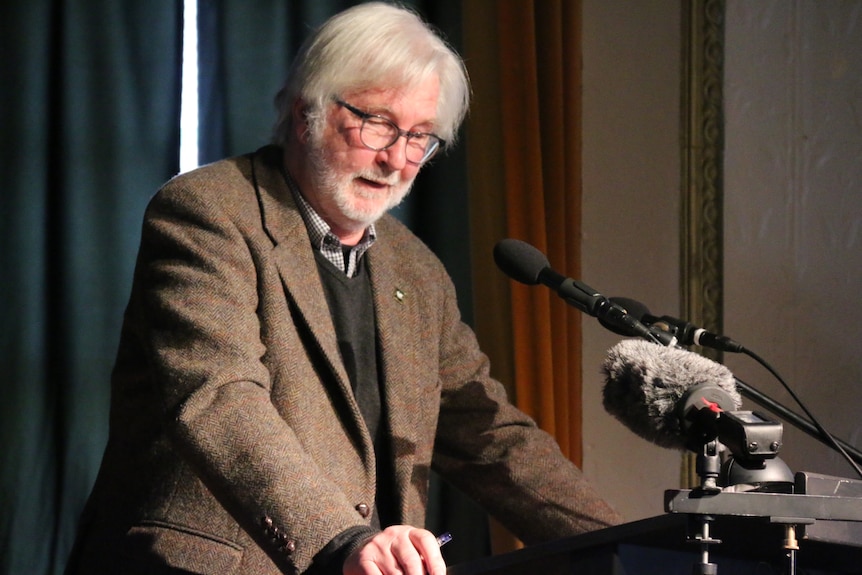 Peter George, president of Neighbours of Fish Farming, speaking at a community meeting.