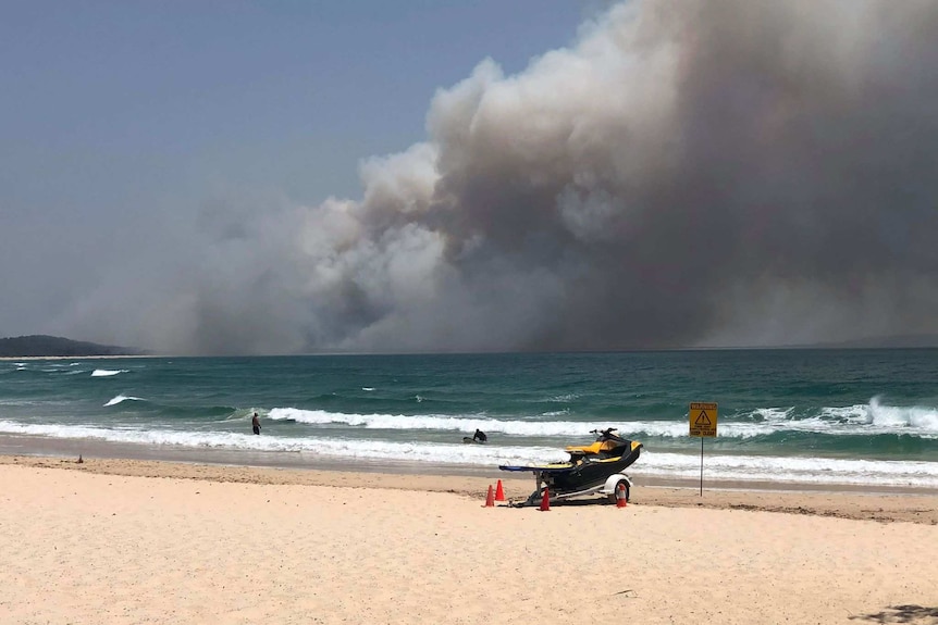 Large plumes of smoke can be seen over the horizon at Noosa North Shore.