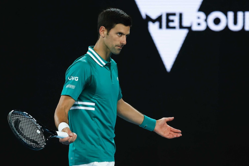 Novak Djokovic as his arms outsretched during his first-round match at the Australian Open.