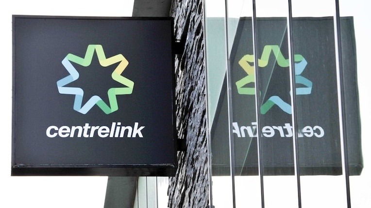 A centrelink sign with on a building with a reflection