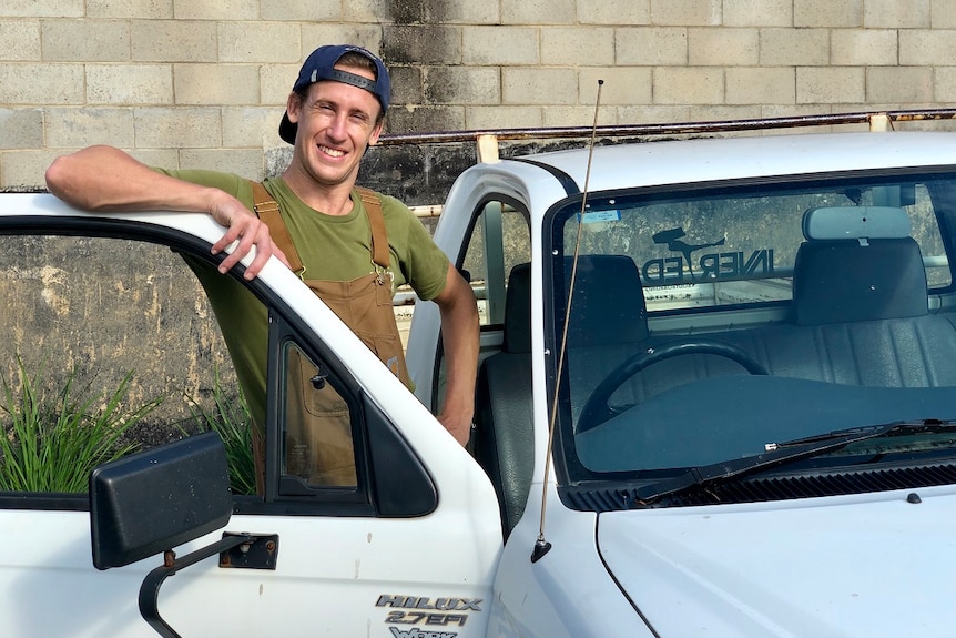 A man stands with his car door open