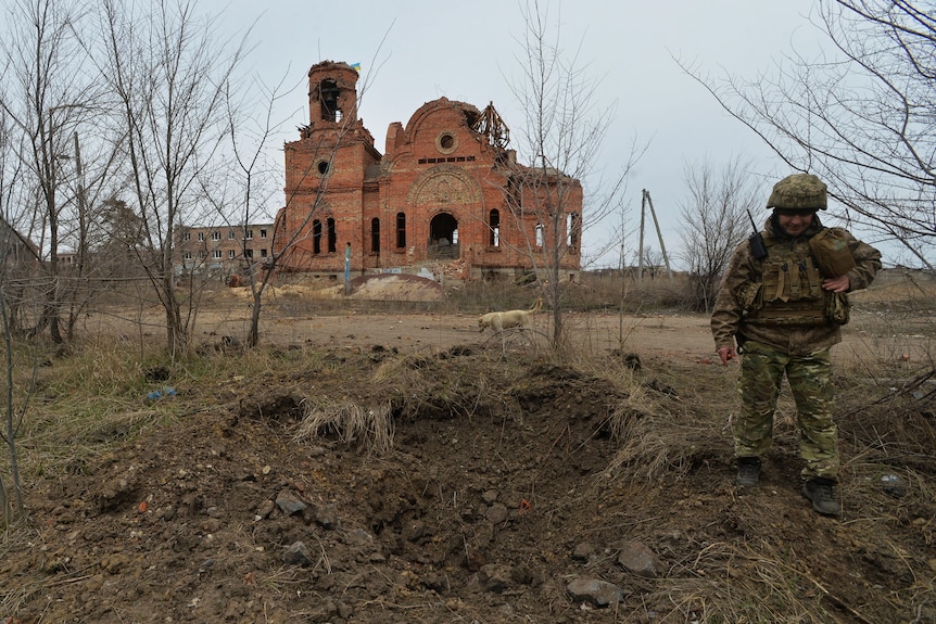A service member of the Ukrainian armed forces is seen at fighting positions in Donetsk