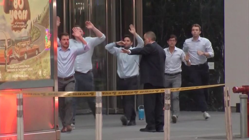 Men in buttoned up shirt with their arms up. 