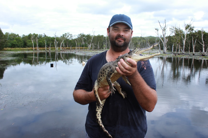 Daniel holding a small crocodile