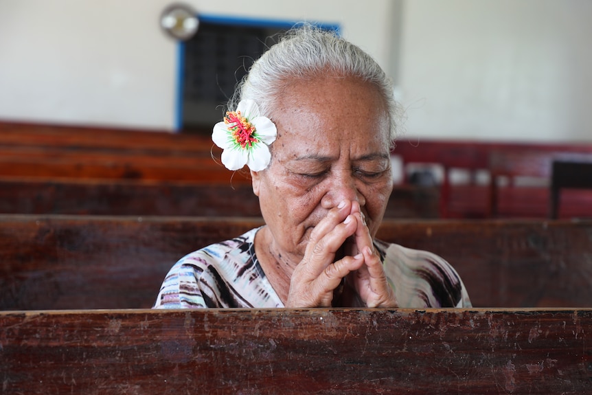 Tineiafi Pedro praying in a church. 