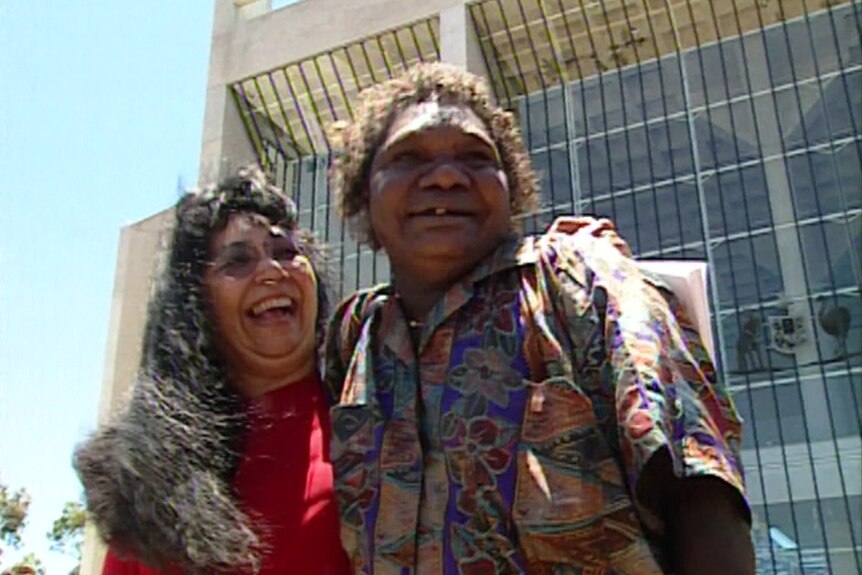 A woman hugs Gladys Tybingoompa outside the High Court 