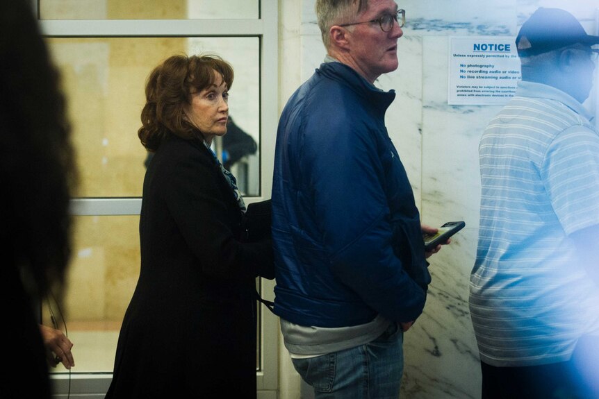 Paul Manafort's wife, Kathleen Manafort, looks over her shoulder as she waits to enter court room.