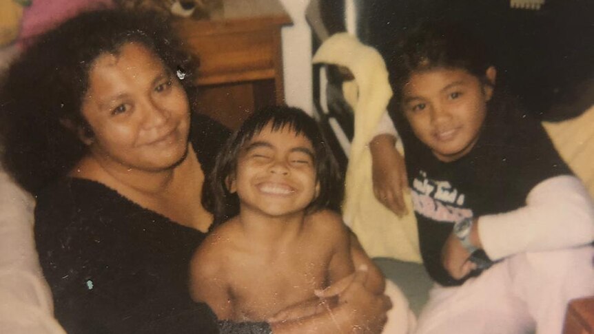 Charisma Amoe-Tarrant with her mother and sister, in an undated photo.
